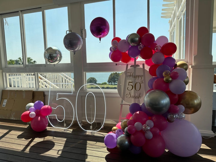 50th Birthday Balloon Garland on Easel with Acrylic Board with Writing and Neon Lights - Everything Party