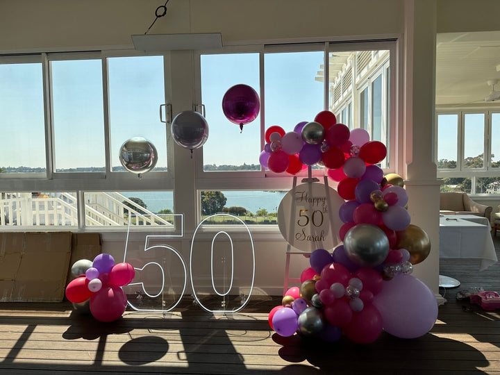 50th Birthday Balloon Garland on Easel with Acrylic Board with Writing and Neon Lights - Everything Party